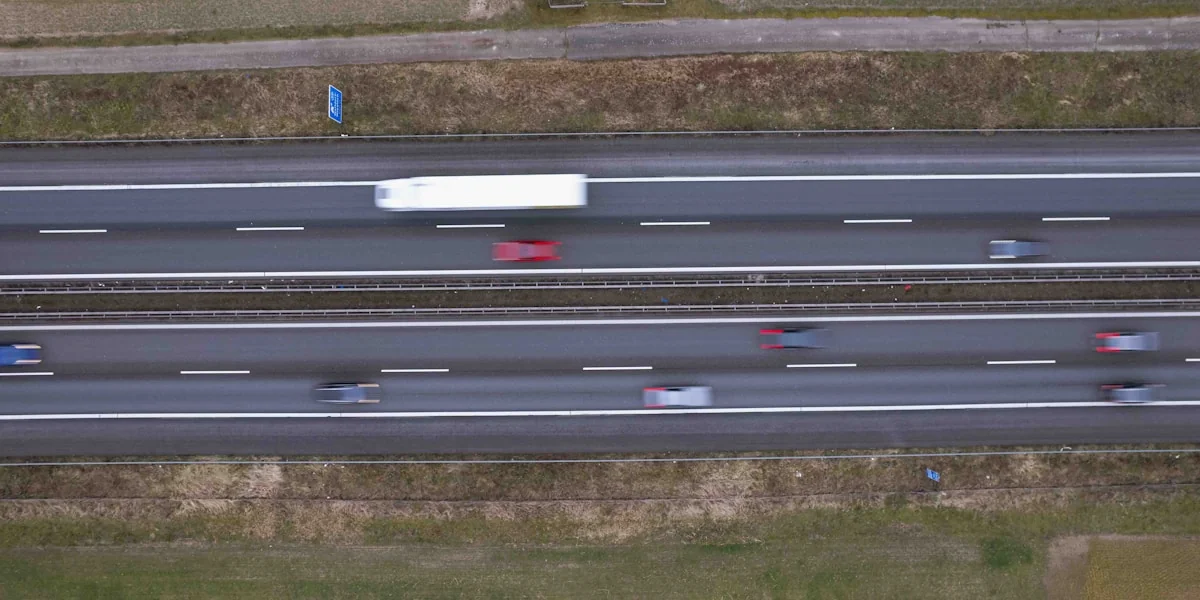 an aerial view of a highway with cars driving on it