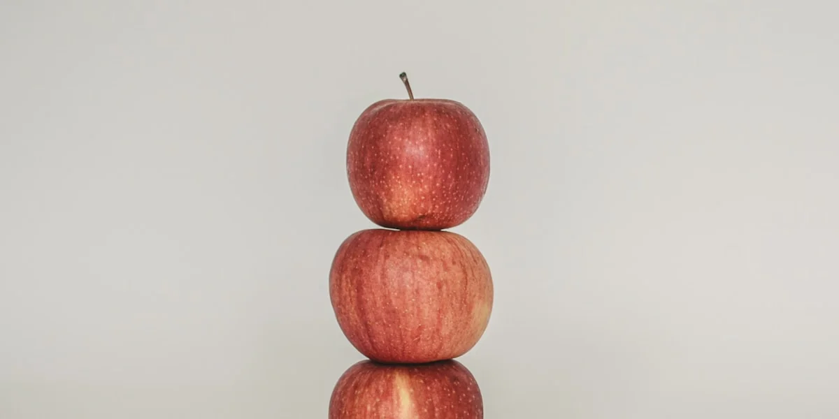 a stack of three apples sitting on top of each other