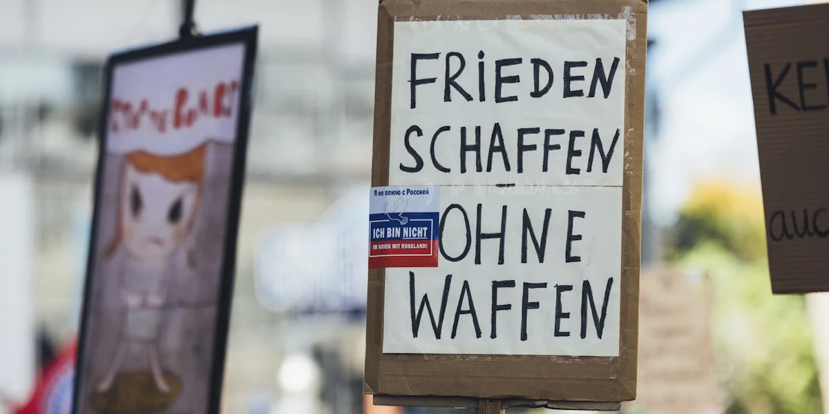 Signs read "create peace without weapons."