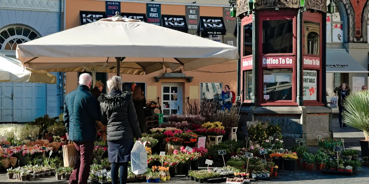 man and woman standing near assorted plants