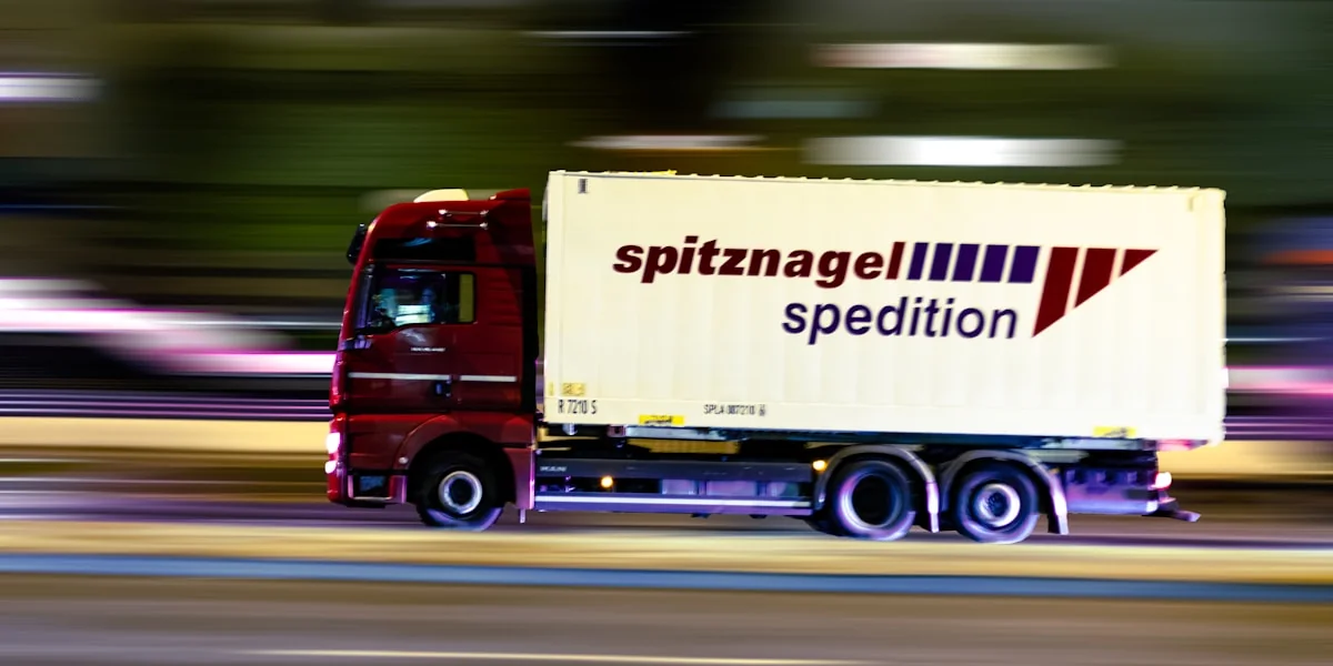 red and white truck on road during daytime