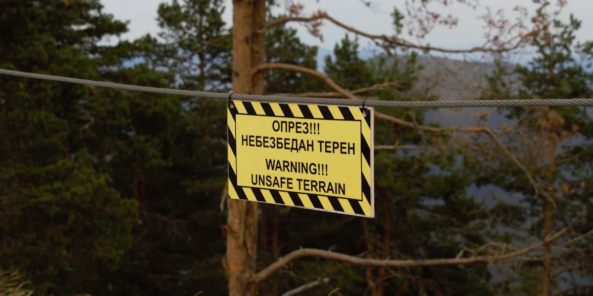 a warning sign is hanging on a power line