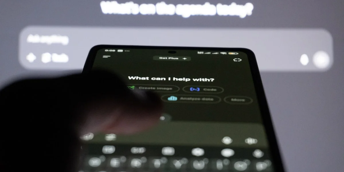 Person typing on smartphone with ai chatbot on screen.