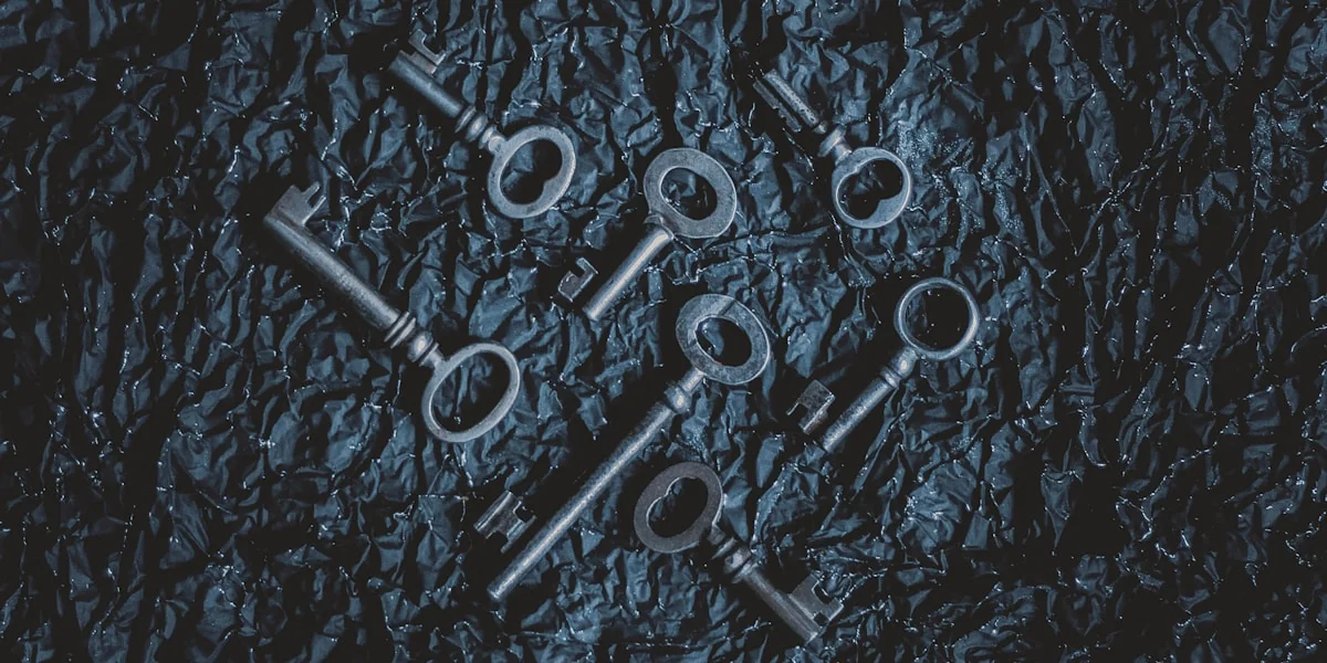 a group of metal keys sitting on top of a table