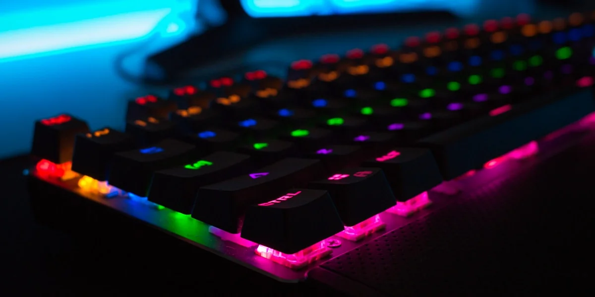 Mensch tippt am Laptop, umgeben von abstrakten Licht- und Datenvisualisierungen