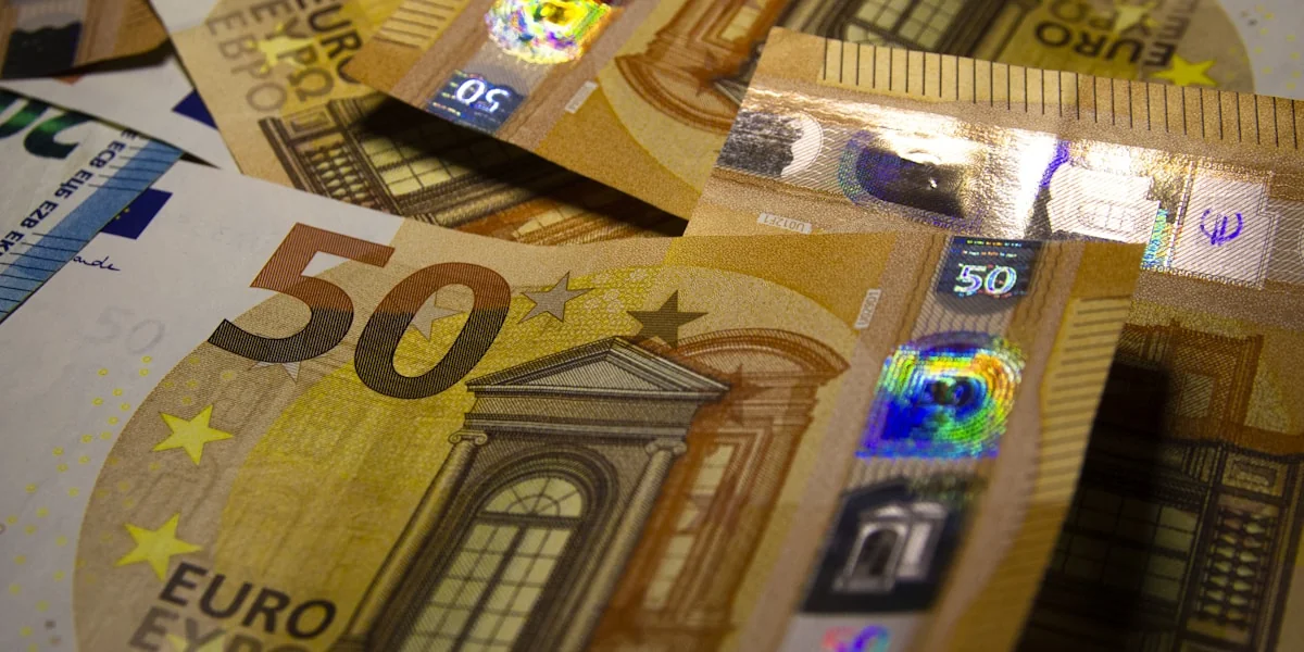 a pile of 50 euro bills sitting on top of each other