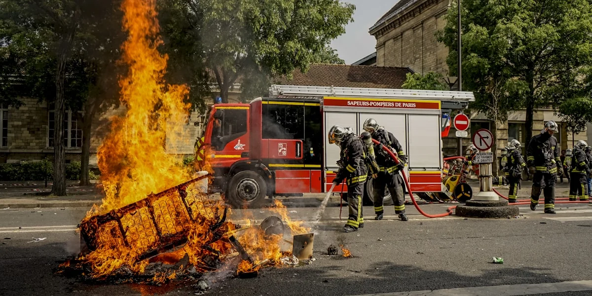 firemen putting out fire during daytime