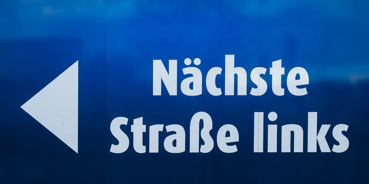 a blue sign with a white arrow pointing to the right