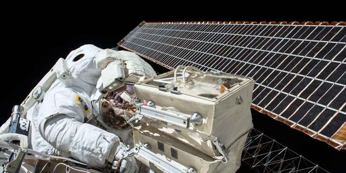 closeup photo of astronaut repairing satellite