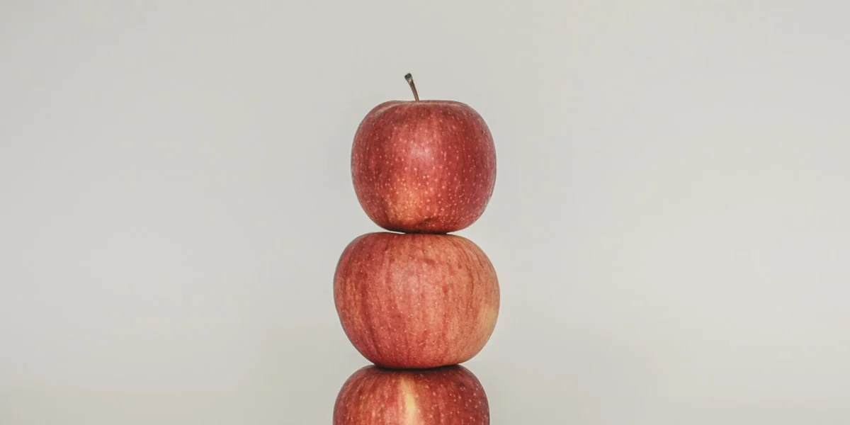 a stack of three apples sitting on top of each other