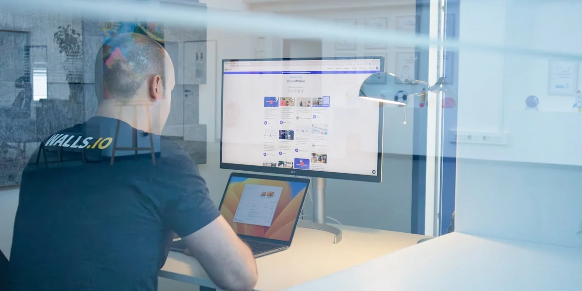 a man sitting at a desk in front of a computer