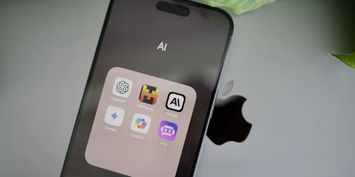 an iphone sitting on top of a table next to a leaf