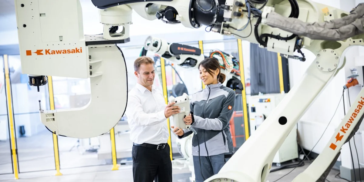 a man and a woman standing in front of a robot