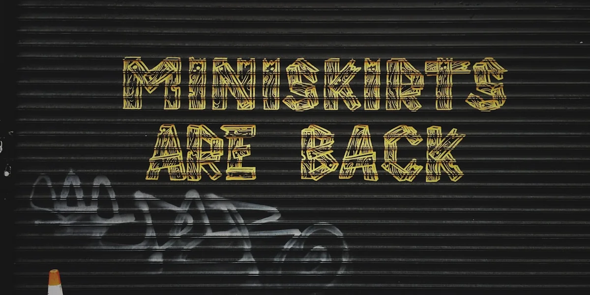 gray background with miniskirts are back text overlay