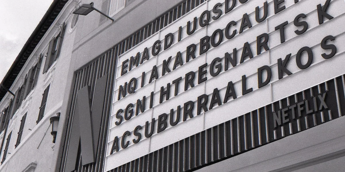 Monochrome building with a netflix sign and scrambled letters.