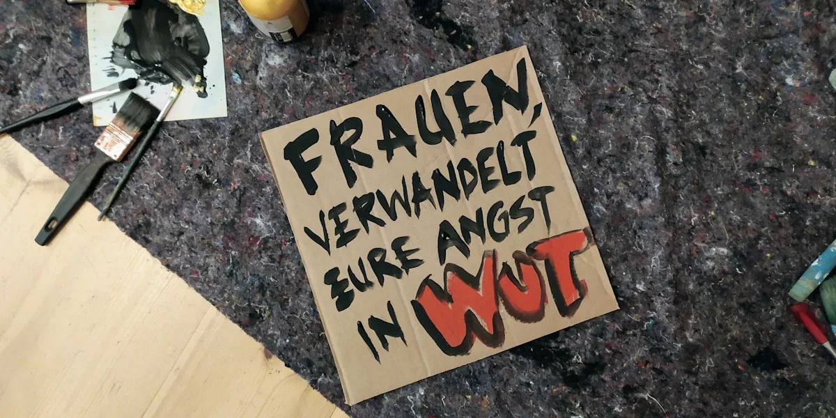 A sign says: "women, transform your fear into rage."