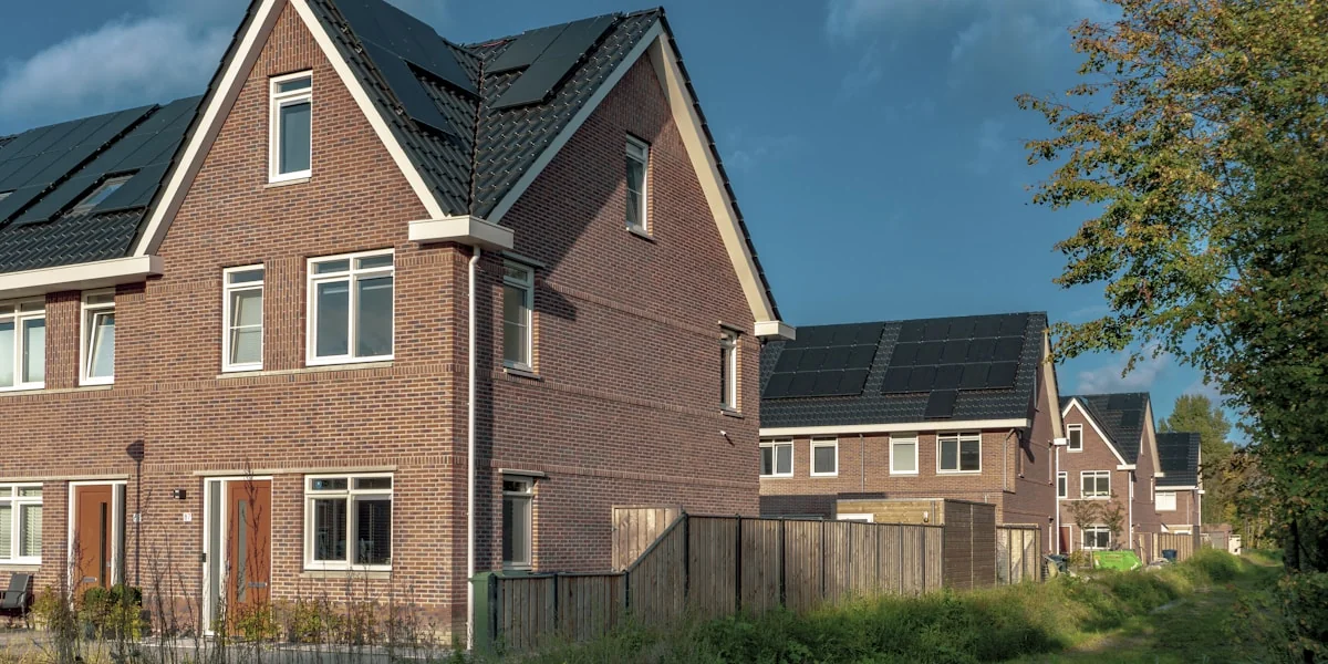 brown brick building near green grass field during daytime