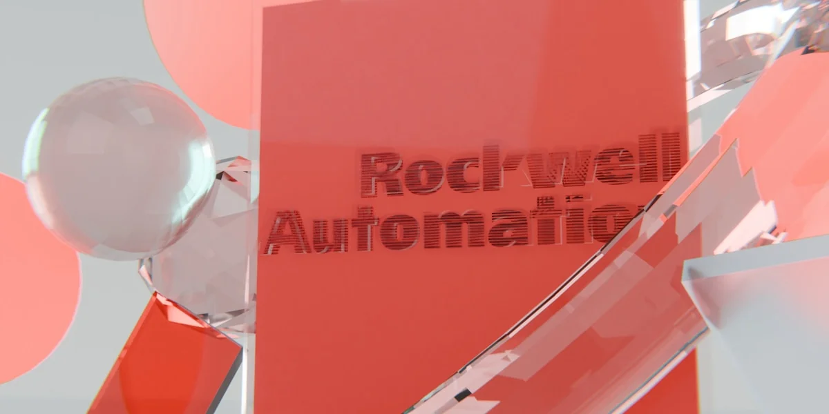 Rockwell automation logo on a red block with abstract shapes