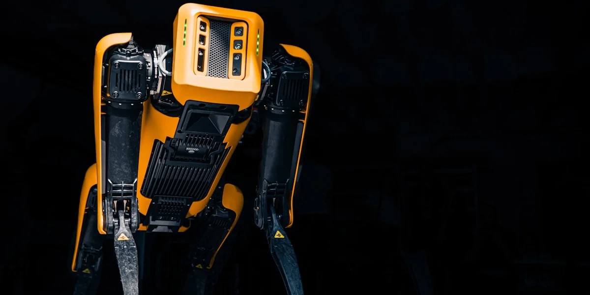 a yellow and black robot standing in the dark