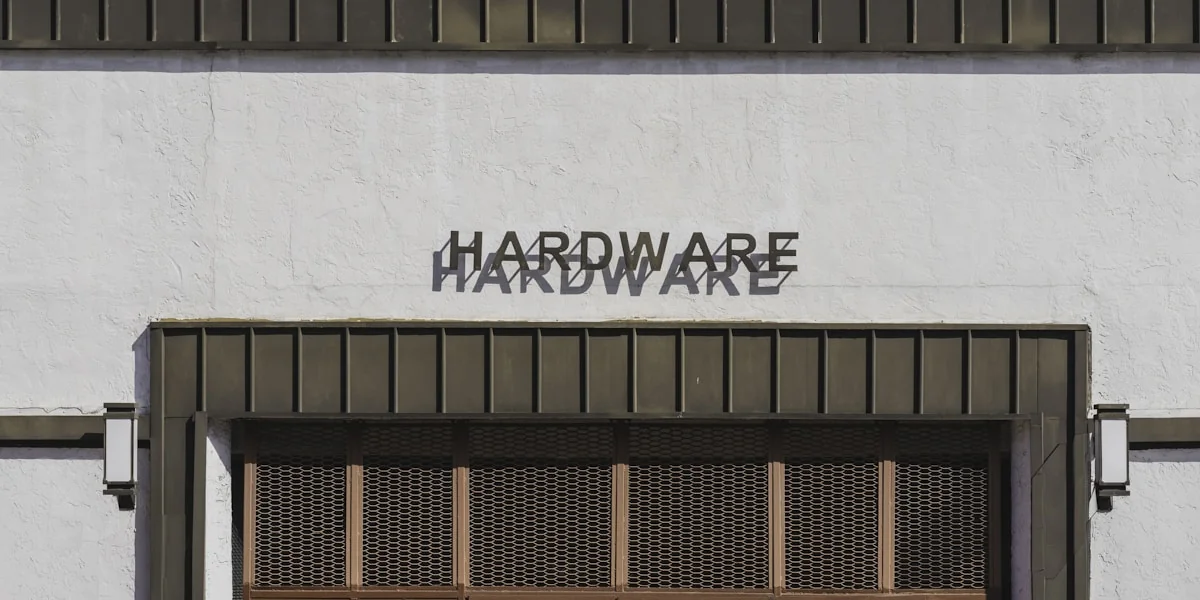 a white building with a sign that says hardware hardware