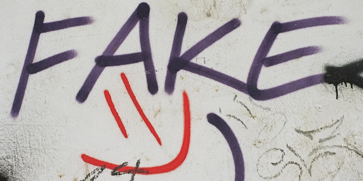 graffiti on a wall that says fake