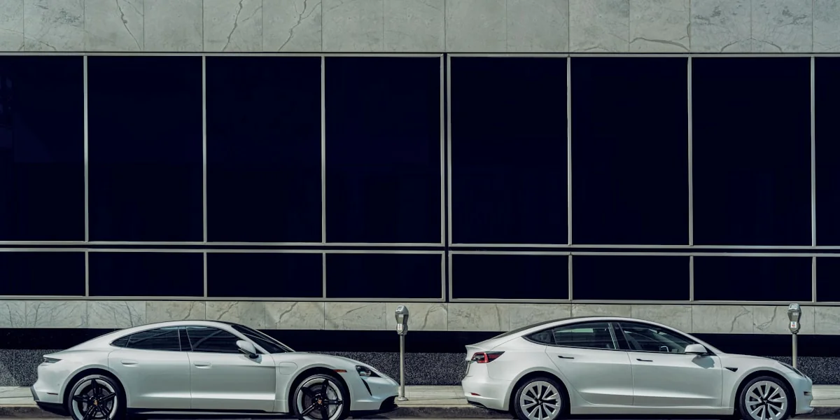 white sedan parked beside white and black building