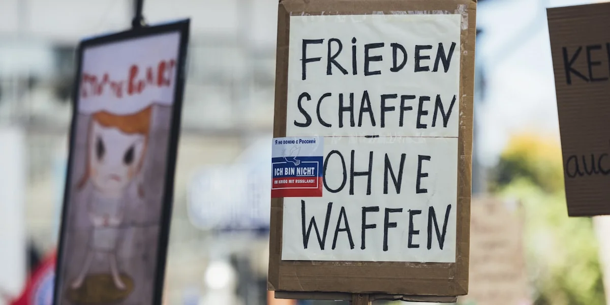 Signs read "create peace without weapons."
