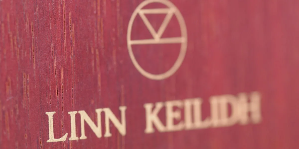 a close up of a red book with a logo on it