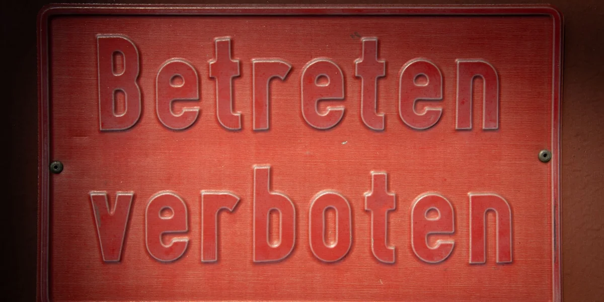Red sign with embossed german text 'betreten verboten'