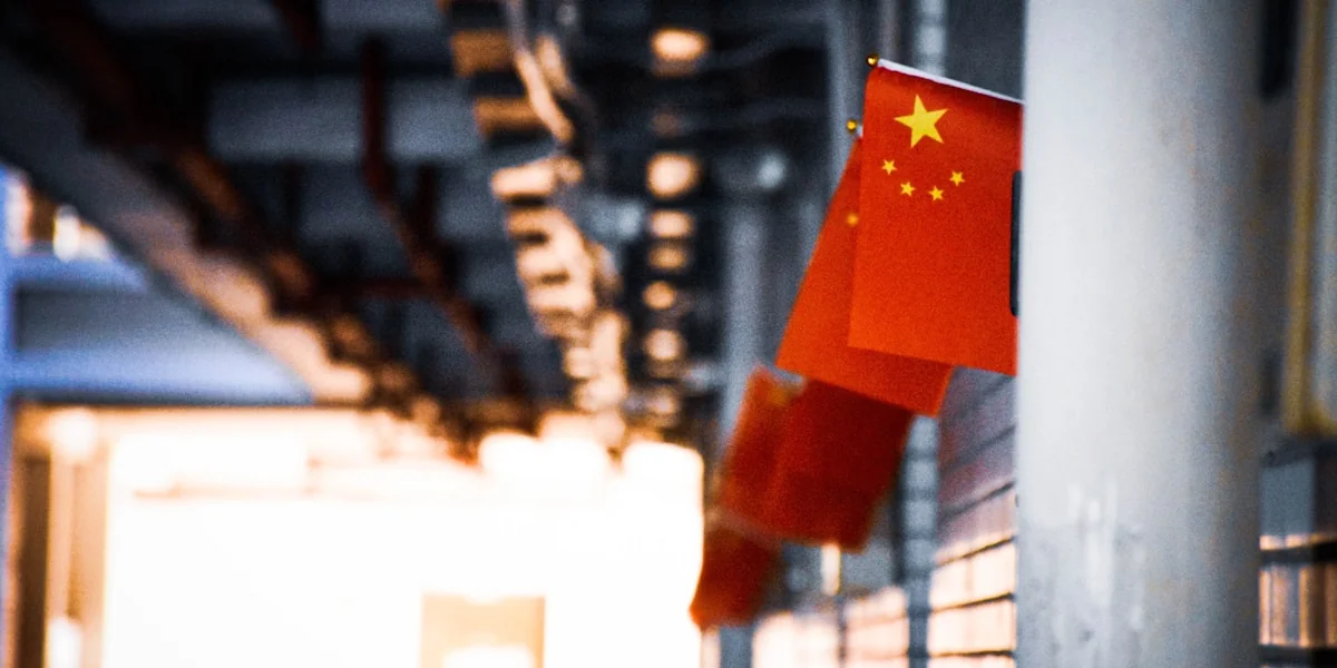a chinese flag hanging from the side of a building