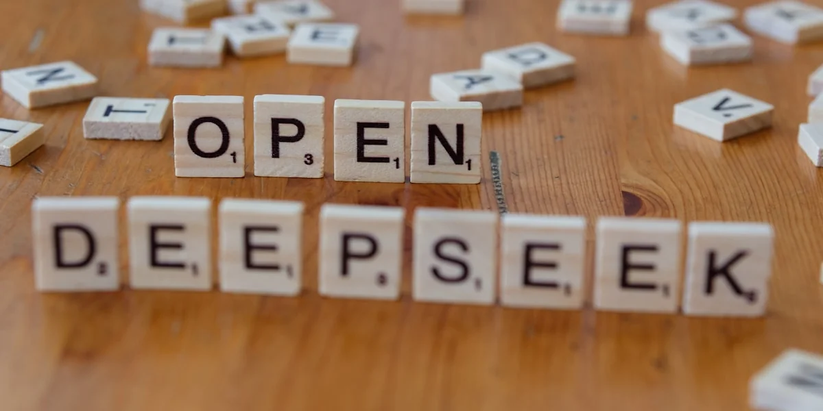 A wooden table topped with scrabble letters spelling open and deep seek