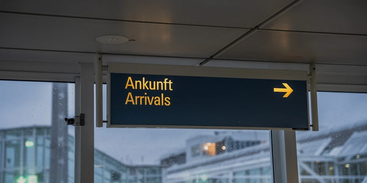an airport sign hanging from the side of a building