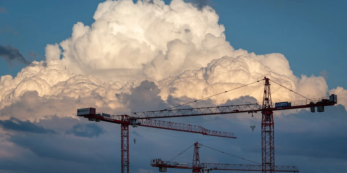 a large cloud looms over a construction site