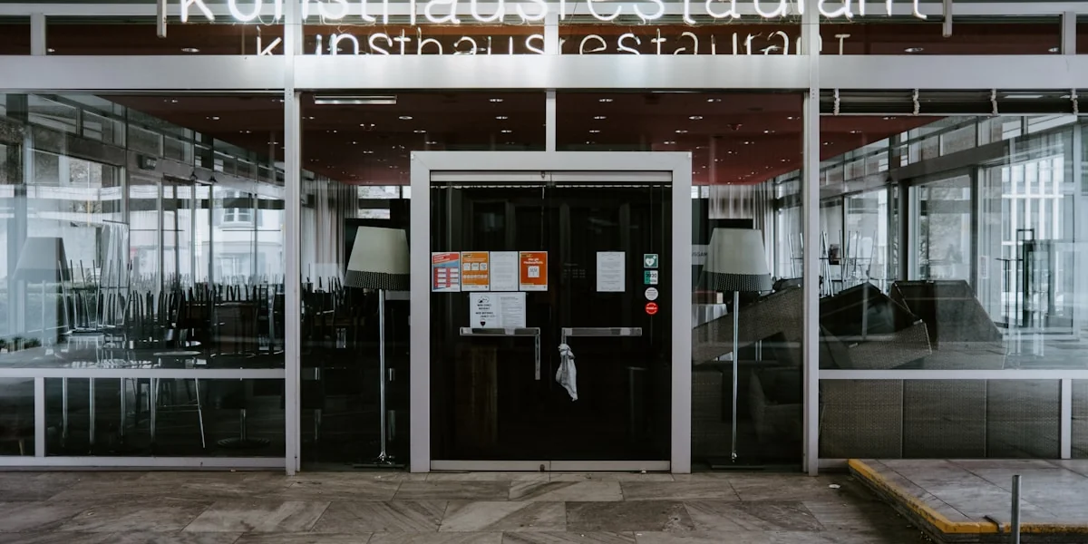 the entrance to a restaurant with glass doors