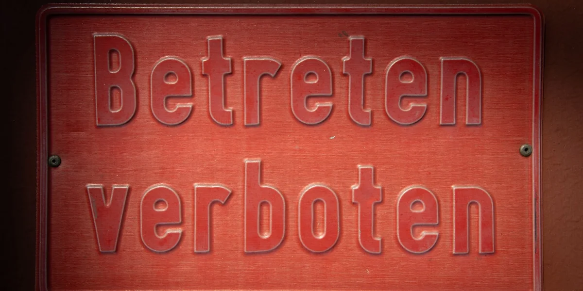 Red sign with embossed german text 'betreten verboten'