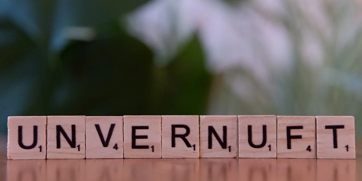 A scrabble type block spelling the word university