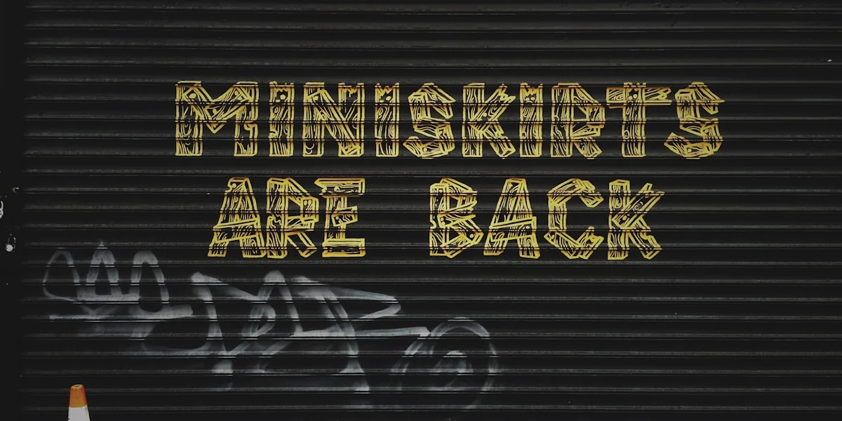 gray background with miniskirts are back text overlay