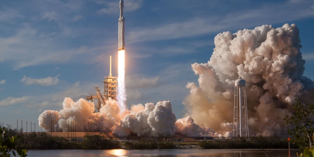 gray spacecraft taking off during daytime