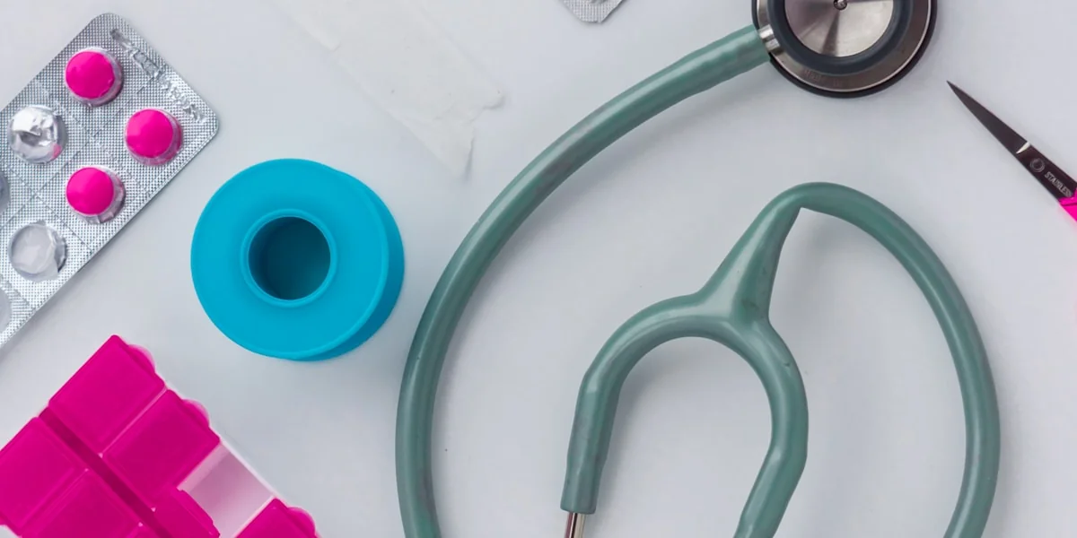 green and silver stethoscope on white envelope