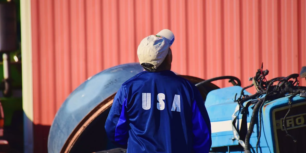 man in blue and black adidas jacket wearing white cap