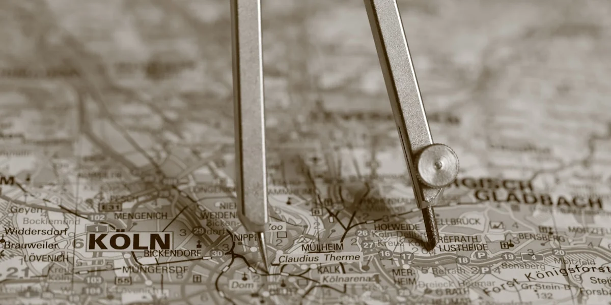 A compass resting on a map with "koln" visible.