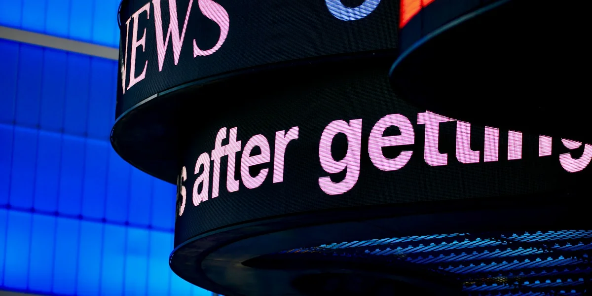 a close up of a sign with a building in the background