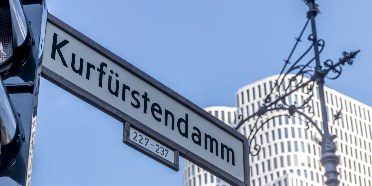 a close up of a street sign hanging from a pole