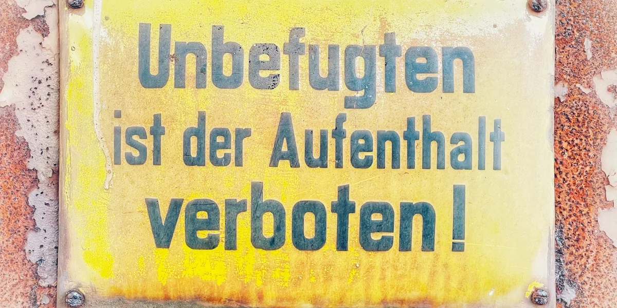 a yellow sign that is on the side of a building